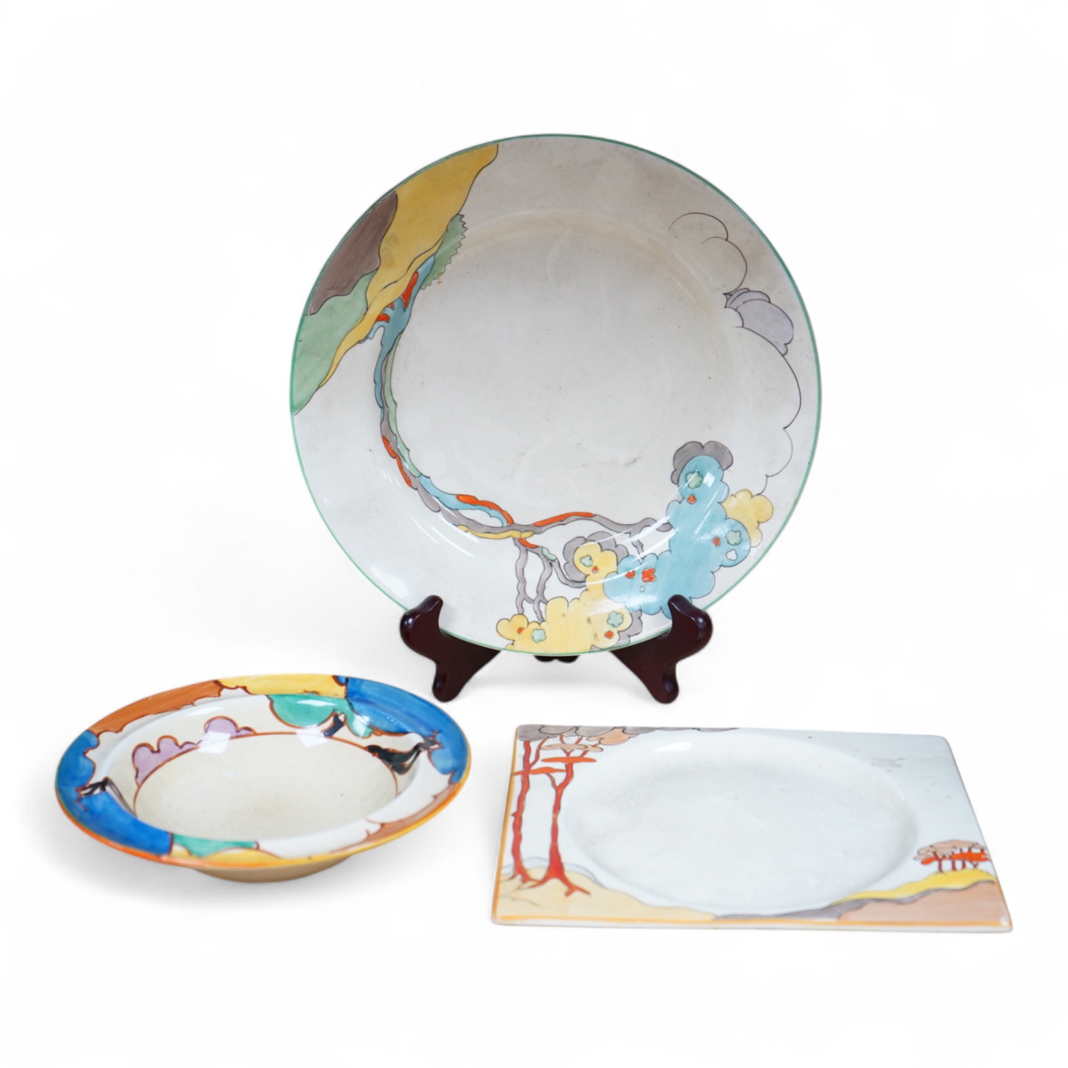 An early 20th century Clarice Cliff Bermuda pattern plate, Blue Autumn bowl and a Coral Firs Bizarre side plate, largest 23cm in diameter